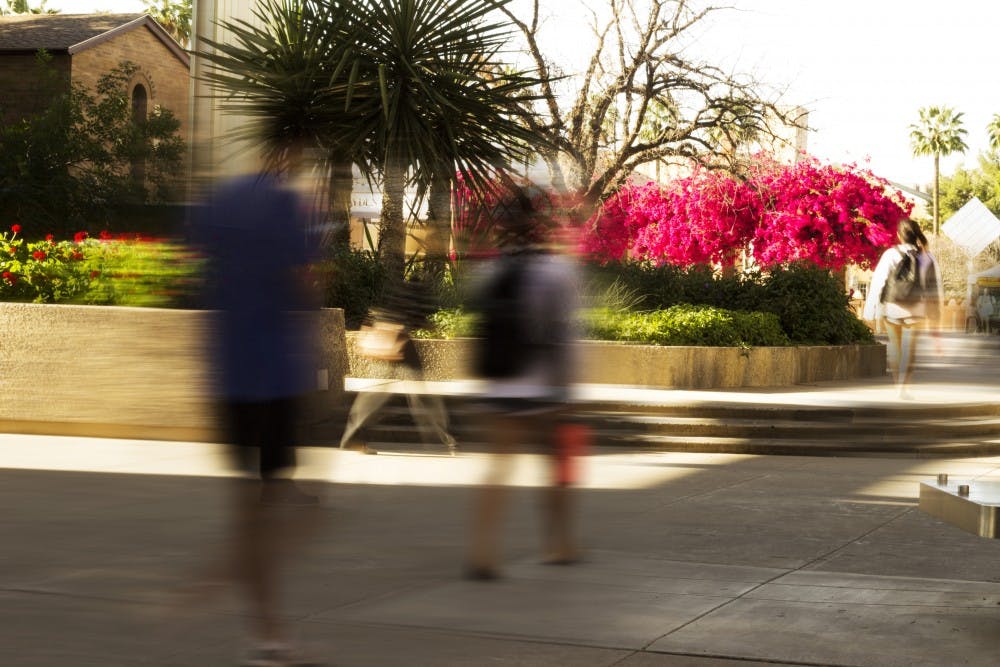 Students walk by the fountain-turned-garden located near Orange St. and Cady Mall at ASU taken on Monday, March 28, 2017. 
