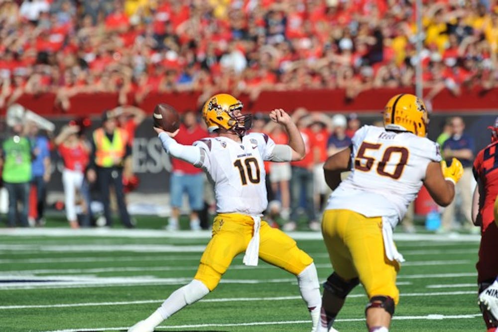 Redshirt senior quarterback Taylor Kelly attempts a pass during the first half of the game against UA on Friday, Nov. 28, 2014. (Photo by Andrew Ybanez)