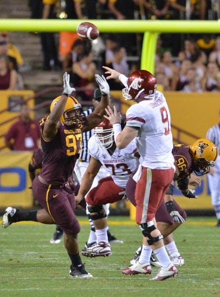 DISRUPTIVE DAY: Freshman defensive end junior Onyeali pressures Washington State redshirt junior quarterback Marshall Lobbestael during Saturday's game. After finishing with three sacks, Onyeali was named Pac-10 Defensive Player of the Week. (Photo by Aaron Lavinsky)