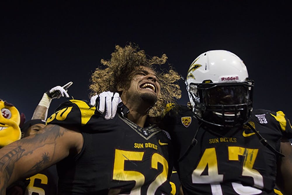 Redshirt Junior defensive end Carl Bradford and graduate defensive end Davon Coleman celebrate after defeating the Wildcats. The Sun Devils will play Stanford in the Pac-12 South Championship. (Photo by Diana Lustig)