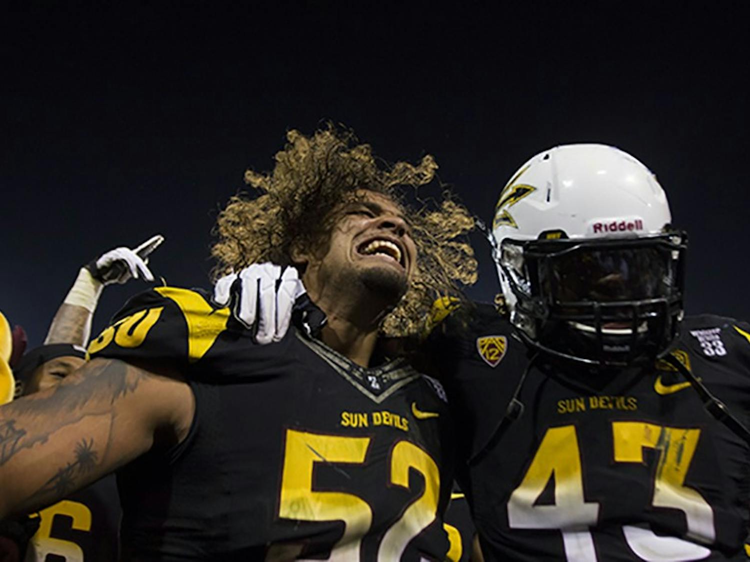 Redshirt Junior defensive end Carl Bradford and graduate defensive end Davon Coleman celebrate after defeating the Wildcats. The Sun Devils will play Stanford in the Pac-12 South Championship. (Photo by Diana Lustig)
