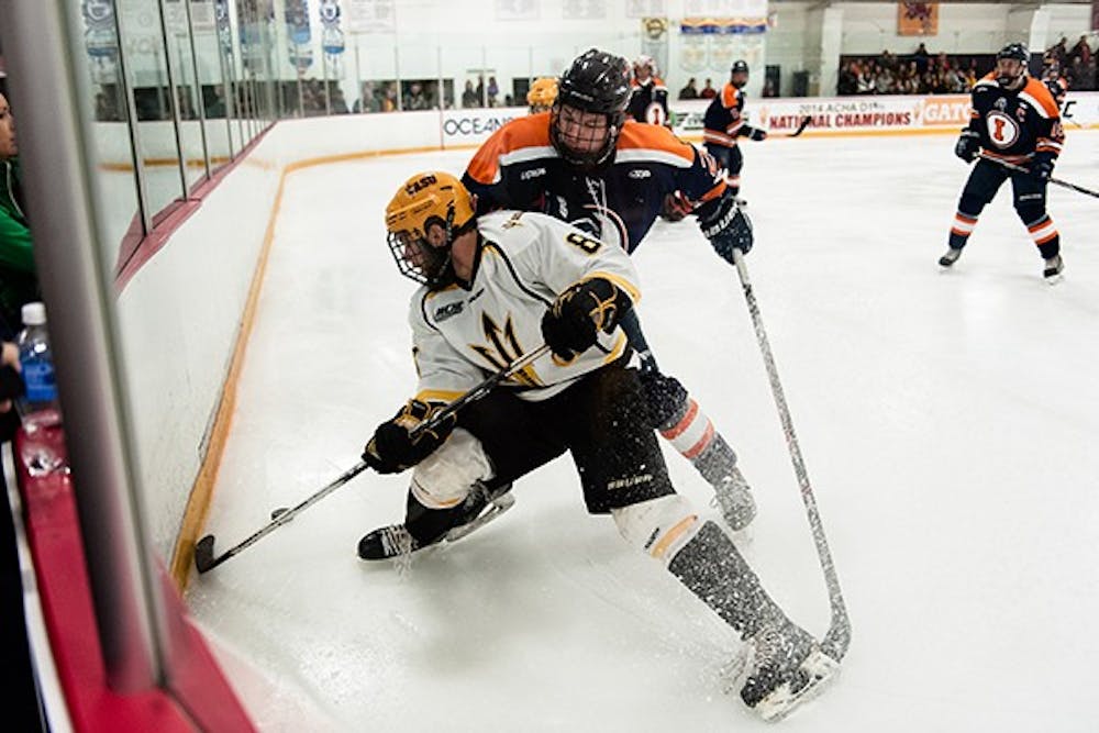 Forward Liam Norris fights for the puck in a game against the University of Illinois, Saturday, Nov. 22, 2014 at Oceanside Ice Arena in Tempe. The Sun Devils defeated the Fighting Illini 3-1. (Photo by Ben Moffat)