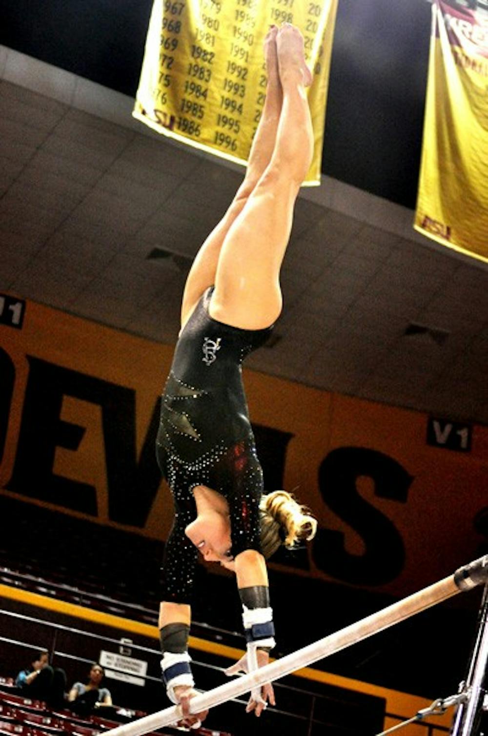 Strictly Vertical: ASU senior Mary Atkinson scores a 9.075 on the bars after slipping off the high bar during a victory over Brown on Jan. 28. She received the same score on the beam after a fall at that event. (Photo by Sierra Smith)