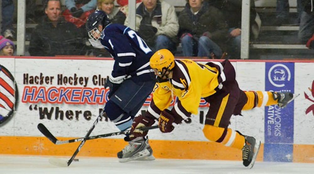 STEALING THE GAME: Forward Mike Granato tries to knock the puck away from a Villanova player during the Sun Devils’ 13-2 victory over the team on Saturday. ASU also beat Villanova 12-2 on Friday. (Photo by Aaron Lavinsky)