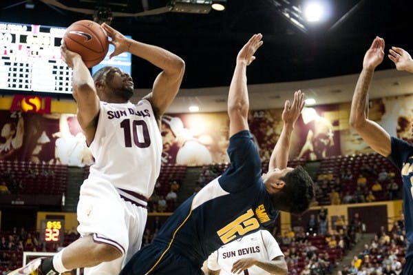 Junior guard Evan Gordon goes over a Cal defender on a layup on Feb. 07.  Gordon’s game winning shot against Colorado on Feb. 16 kept ASU’s tournament hopes alive. (Photo by Molly J. Smith)