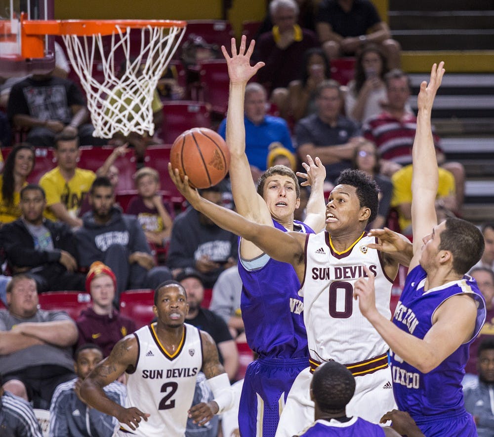 Sophomore guard Tra Holder (0) fights to get past Western New Mexico defenders during the second half of an exhibition game at Wells Fargo Arena in Tempe on Saturday, Nov. 7, 2015. The Sun Devils defeated Western New Mexico 102-34.