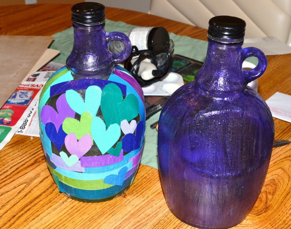 Taken by Faith Breisblatt; two different glass bottles, both of which were painted with the glue and food coloring mixture and one was also Mod Podged with paper.