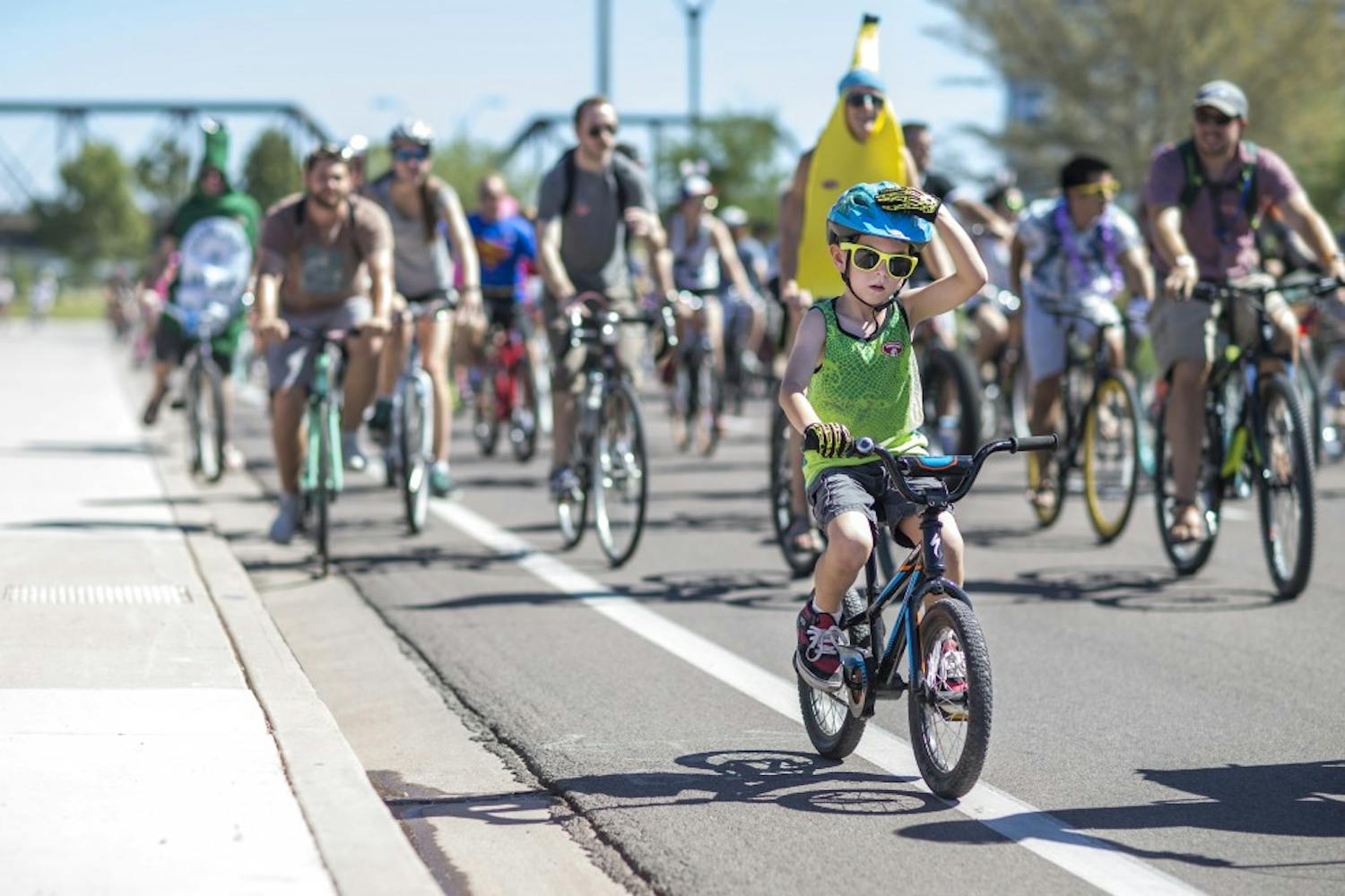 Bikers ride down W Rio Salado Pkwy during the bike parade on Saturday, Oct. 3, 2015. The annual Tour de Fat celebration features a costumed bike parade around Tempe.