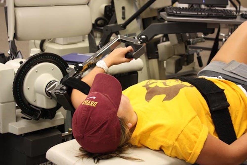 TESTINJG TOUGHNESS: Sophomore Nicole Smith gets her shoulder strength analyzed at Physiotherapy Associates in Scottsdale. (Photo by Nicole Klauss)