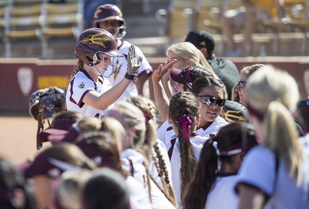 ASU right fielder Nichole Chilson high-fives teammates after scoring a run during a game against Fresno State on Sunday, Feb. 28, 2016. The Sun Devils won the game in five innings, 11-3. 