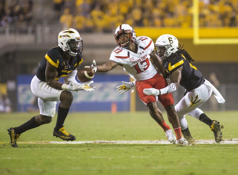 ASU redshirt senior Gump Hayes (8), left, catches an interception in the fourth quarter of a game against the Texas Tech Raiders in Sun Devil Stadium on Saturday, Sept. 10, 2016. 