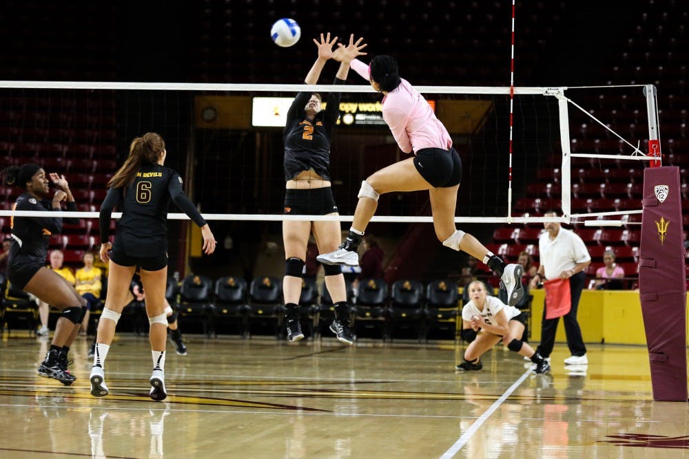 Freshmen BreElle Bailey jumps to spike the ball over the net during a volleyball game at Wells Fargo Arena. ASU won 3-0 against University of Oregon. (Photo by Arianna Grainey)
