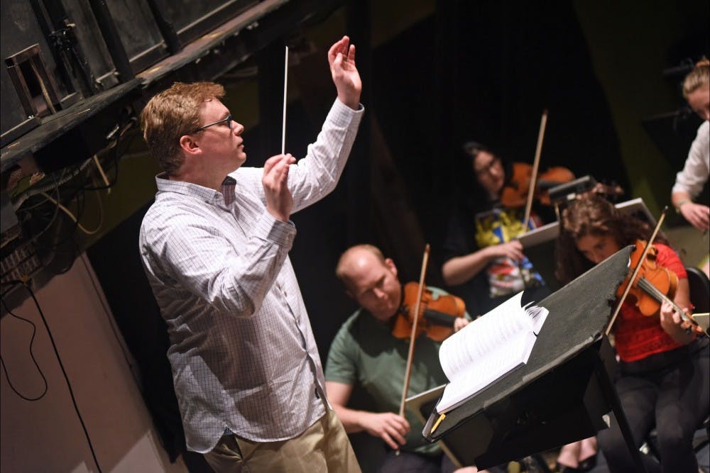 LOT Artistic Director Brian DeMaris rehearses an opera pit orchestra.&nbsp;