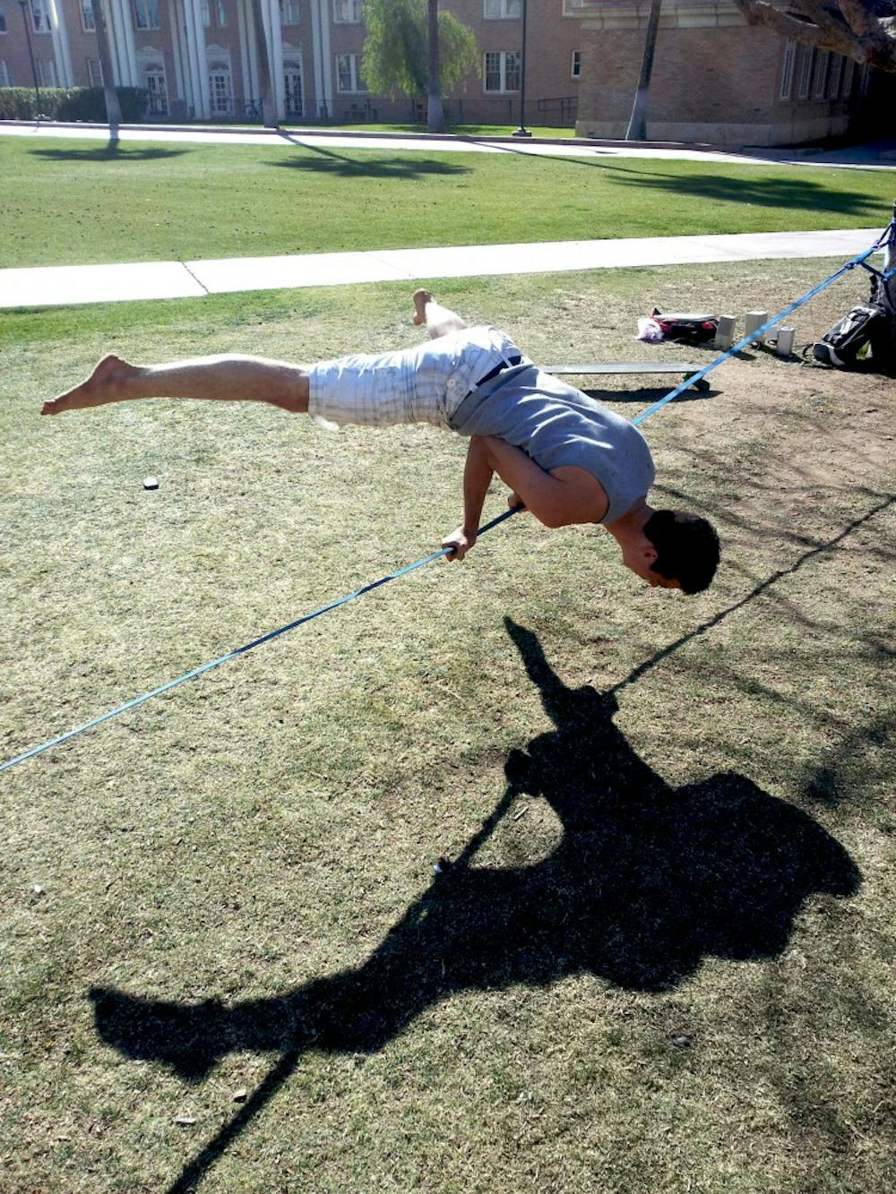 Josh Brown doing acrobatics on the line. Photo by Brendan Capria.