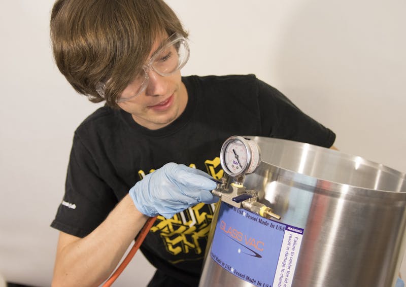 ASU electrical engineering graduate student John Patterson plugs a tube into the sterilization unit on Tuesday, June 23, 2020.