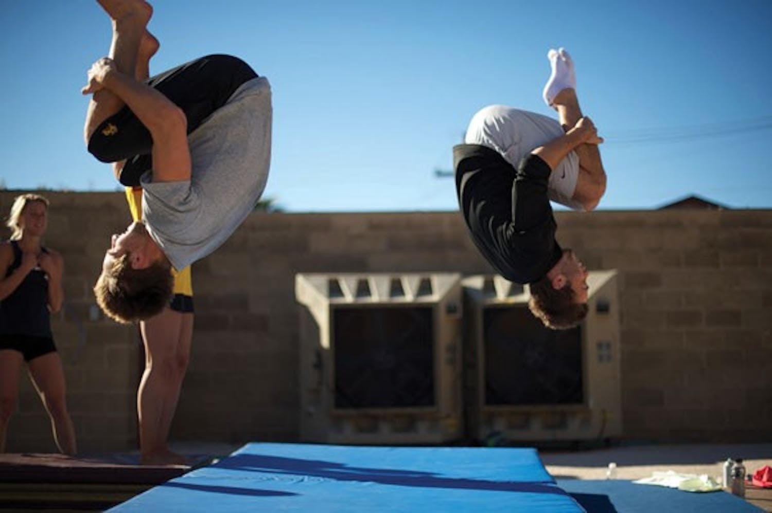 Riley McCormick (left) and Cameron Bradshaw of the ASU diving team train on a trampoline during a Jan. 13, 2011 practice. (Photo by Michael Arellano)