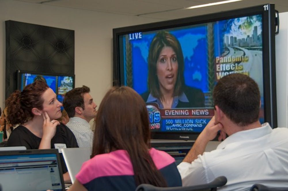 Students from UA, NAU and ASU participating in a statewide pandemic flu exercise on Tuesday at UA's Health Sciences Education building in downtown Phoenix watch a mock newscast describing the simulated flu outbreak in the drill. (Photo courtesy of Sun Czar Belous, UA College of Medicine – Phoenix)