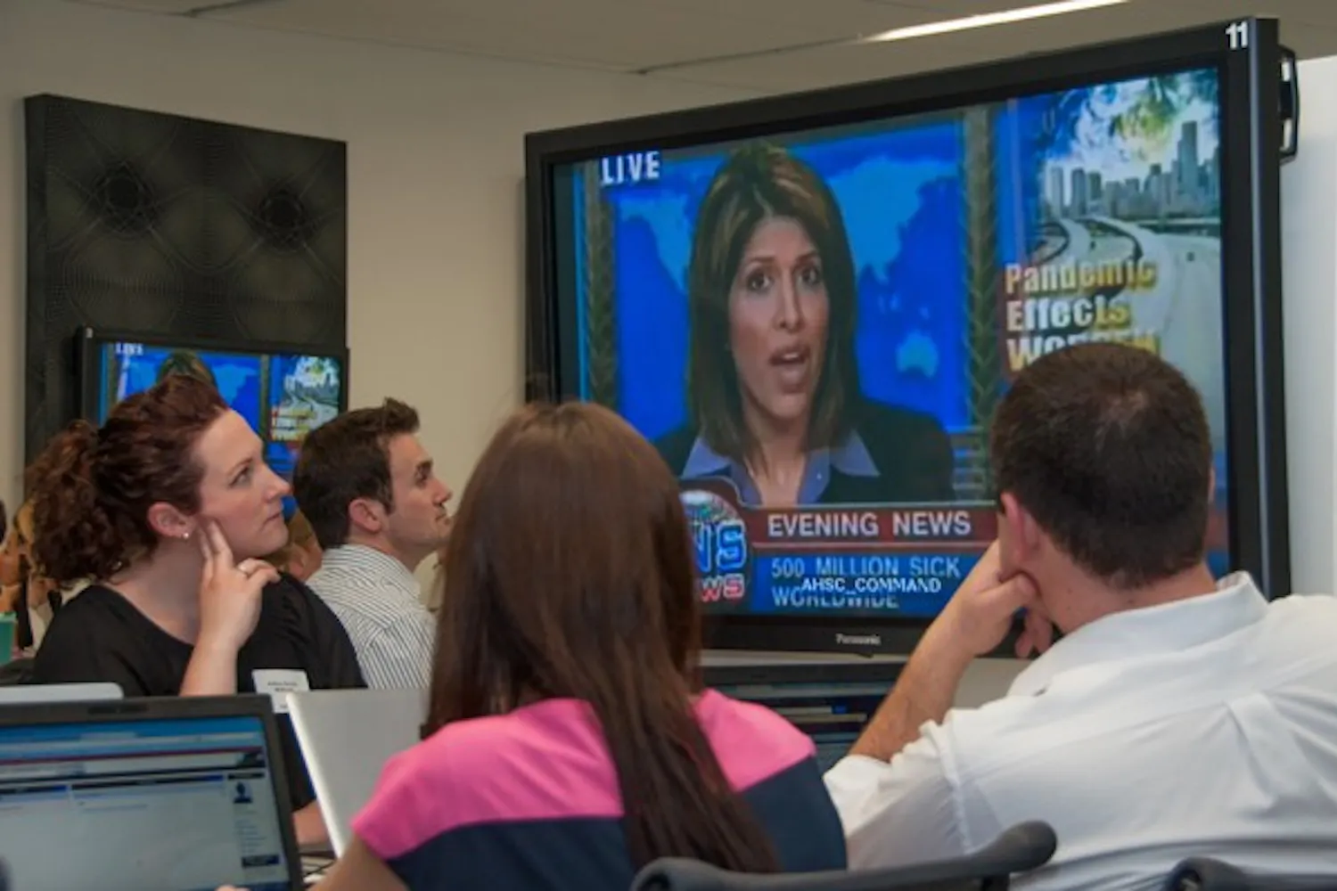 Students from UA, NAU and ASU participating in a statewide pandemic flu exercise on Tuesday at UA's Health Sciences Education building in downtown Phoenix watch a mock newscast describing the simulated flu outbreak in the drill. (Photo courtesy of Sun Czar Belous, UA College of Medicine – Phoenix)