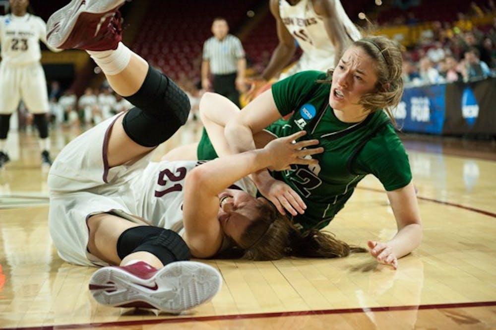 Sophomore forward Sophie Brunner falls to the ground under an Ohio defender in the first round of the NCAA women's tournament on Saturday, March 21, 2015, at Wells Fargo Arena in Tempe. The Sun Devils defeated the Bobcats 74-55. (Ben Moffat/The State Press)