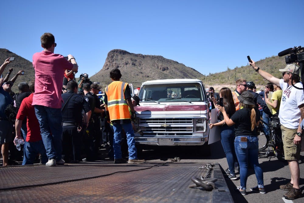 A car blocking the route in protest to a Trump rally is towed on Saturday, March 19, 2016.
