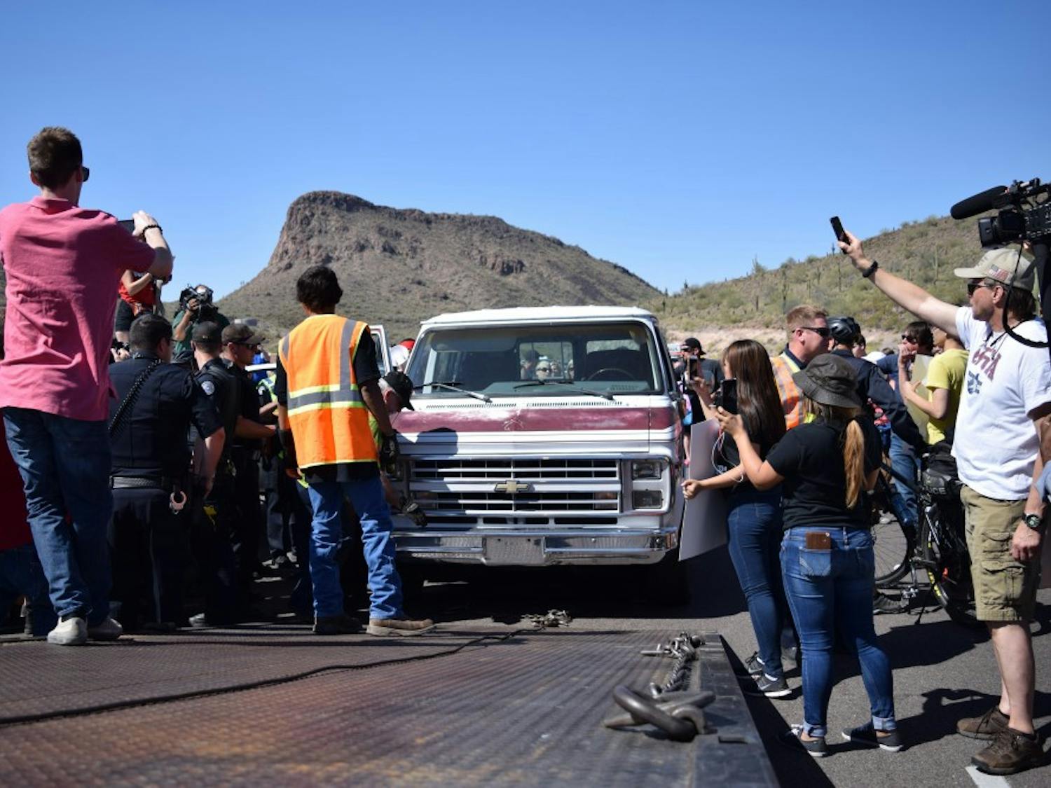 A car blocking the route in protest to a Trump rally is towed on Saturday, March 19, 2016.