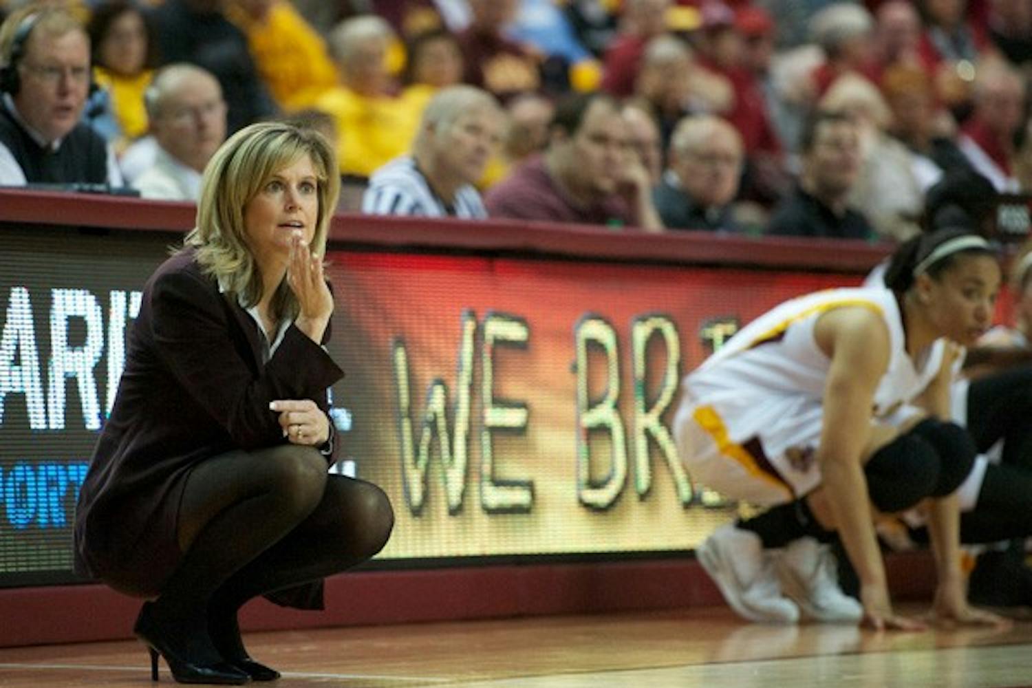 Buckling down: ASU coach Charli Turner Thorne gives out directions during the Feb. 3 game against Stanford while freshman guard Adrienne Thomas waits in the background. The Sun Devils are tied for third in the conference with USC, whom they face on Thursday. (Photo by Michael Arellano)