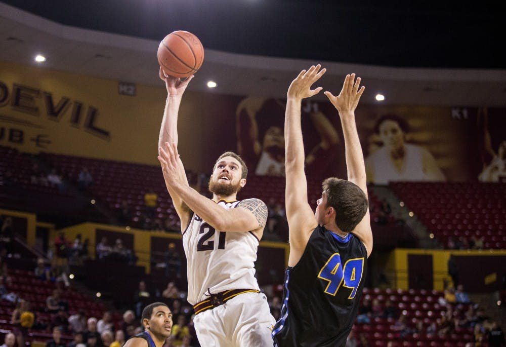 Arizona State Sun Devils forward Eric Jacobsen, left, takes a shot over UCSB forward Sam Beeler during a game against UC Santa Barbara at Wells Fargo Arena in Tempe, Ariz., on Sunday, Nov. 29, 2015. The ASU Sun Devils took down the UC Santa Barbara Gauchos, 70-68.