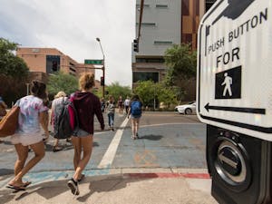 Pedestrians cross the street at the intersection of 1st and Taylor streets on the Downtown campus on Sept. 19, 2016.