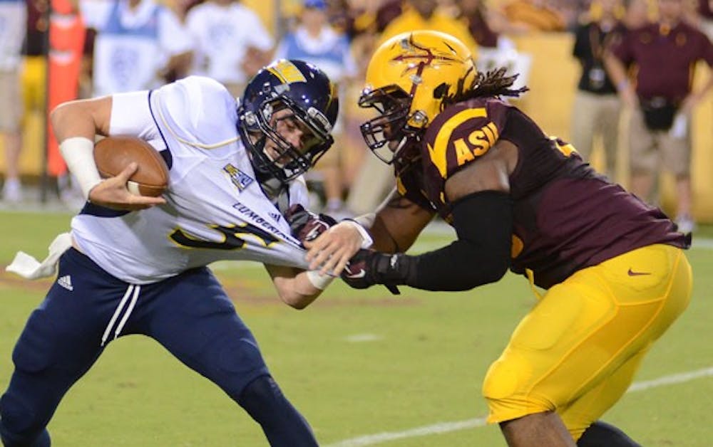 Redshirt junior defensive tackle Will Sutton pulls down NAU senior quarterback Cary Grossart during the Sun Devils’ 63-6 win over the Lumberjacks on Aug. 30. (Photo by Aaron Lavinsky)