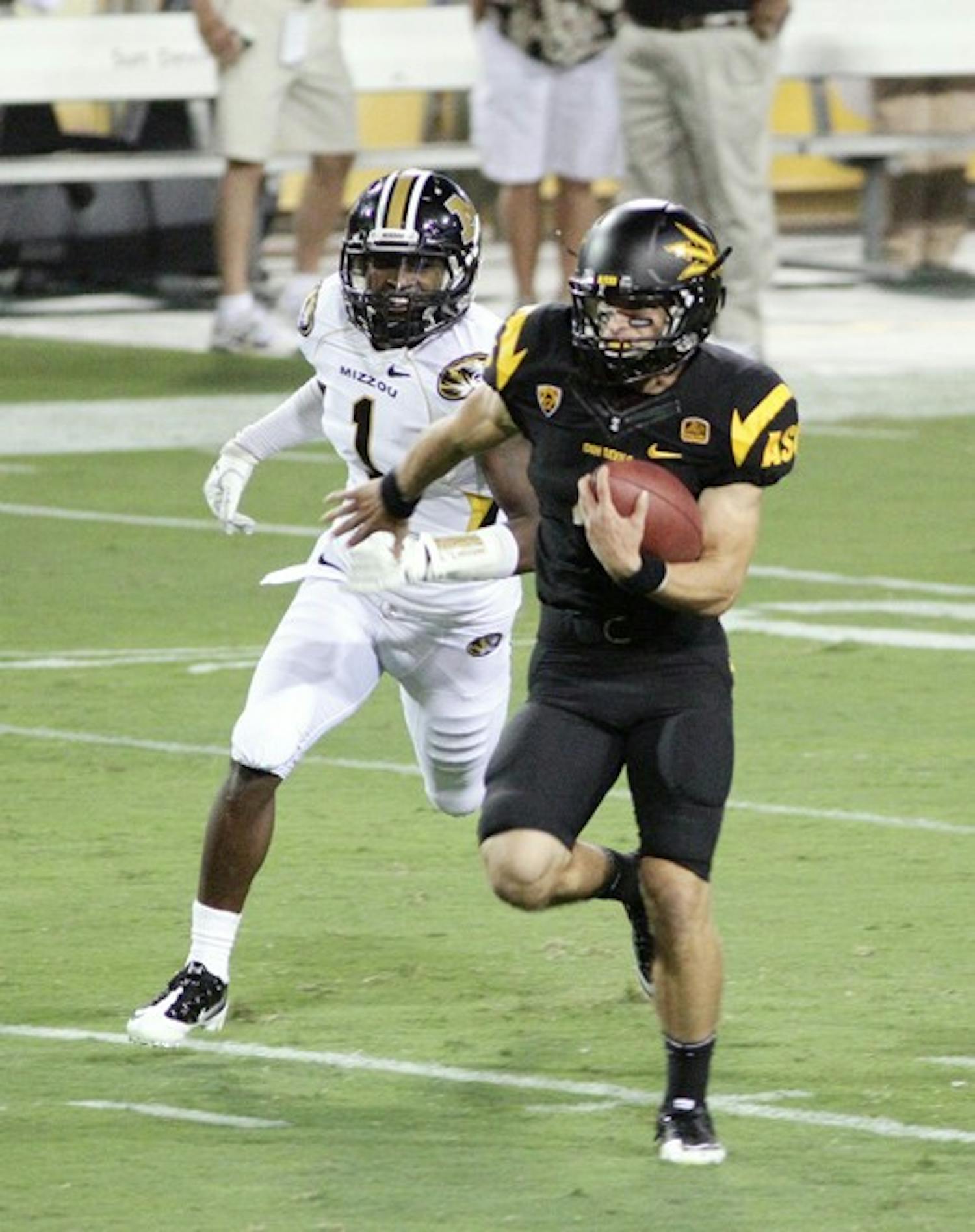 BREAKING FREE: ASU senior wide receiver Aaron Pflugrad carries the ball for a touchdown while Missouri redshirt junior defensive back Kip Edwards gives chase during Friday’s 37-30 overtime win over the Tigers. (Photo by Beth Easterbrook)