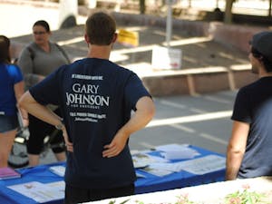 President of Youth for Johnson/Weld&nbsp;David Howman stands behind his club's table at the Memorial Union on Friday Sept. 9.&nbsp;