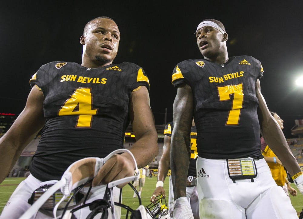 ASU juniors Demario Richard (4) and Kalen Ballage (7) walk off the field after a game against the Texas Tech Red Raiders in Sun Devil Stadium on Saturday, Sept. 10, 2016. 