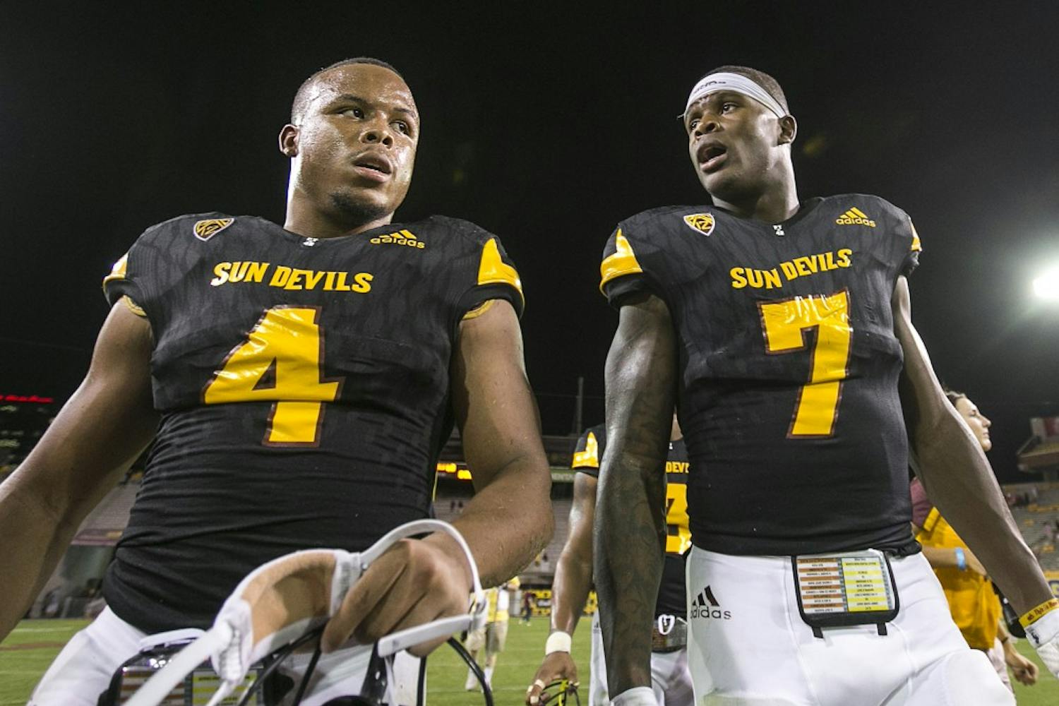 ASU juniors Demario Richard (4) and Kalen Ballage (7) walk off the field after a game against the Texas Tech Red Raiders in Sun Devil Stadium on Saturday, Sept. 10, 2016. 
