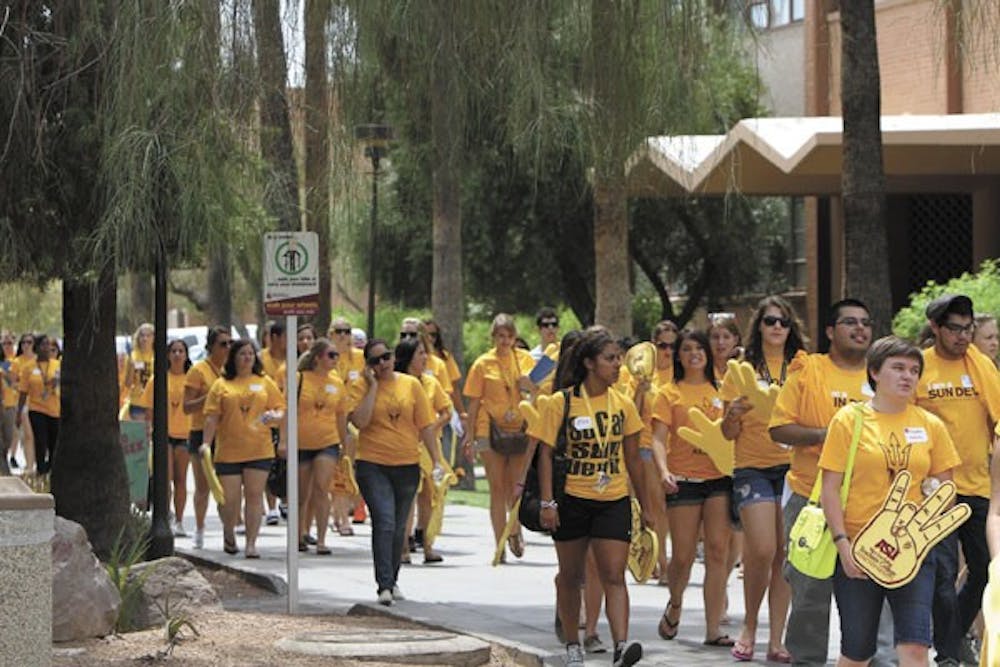 Members of the class of 2016 stroll down Palm Walk on Tuesday. They were on their way to the fall welcome concert, featuring B.o.B. and Far East Movement. (Photo by Sam Rosenbaum)