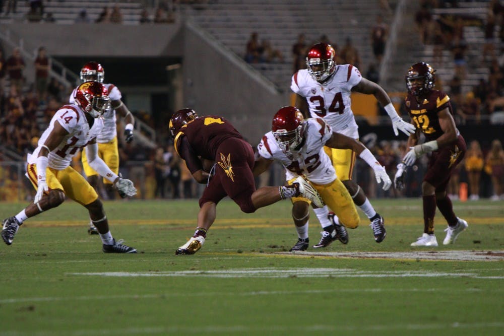 Sophomore running back Demario Richard (4) runs for a gain of yards in the fourth quarter against University of Southern California Saturday, Sept. 26, 2015 at Sun Devil Stadium in Tempe. The Trojans defeated the Sun Devils 42-14. 