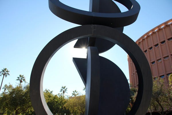 The sunlight peeps out from behind a sculpture outside of ASU Gammage on the Tempe campus Thursday afternoon. (Photo by Diana Lustig)