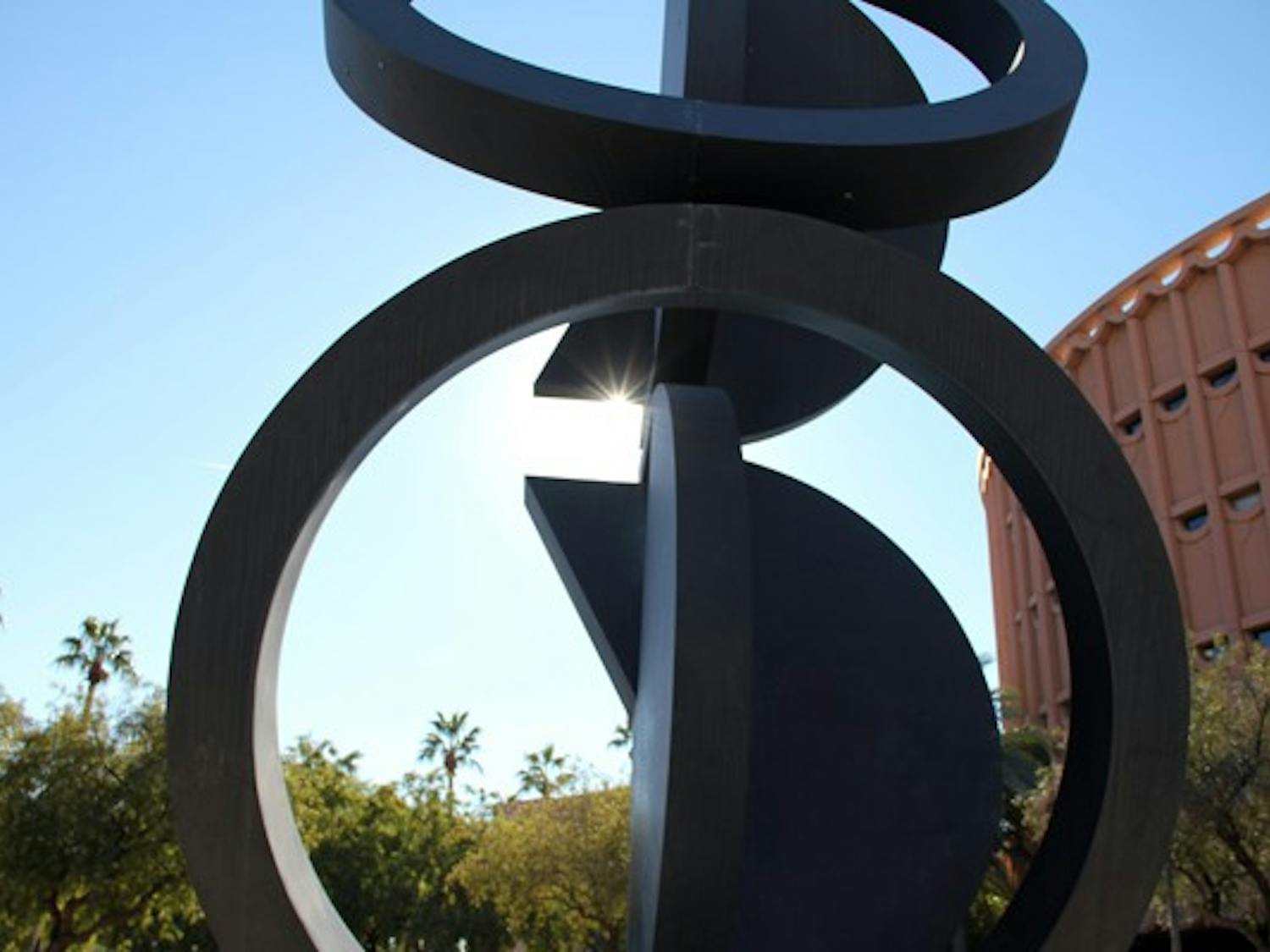 The sunlight peeps out from behind a sculpture outside of ASU Gammage on the Tempe campus Thursday afternoon. (Photo by Diana Lustig)