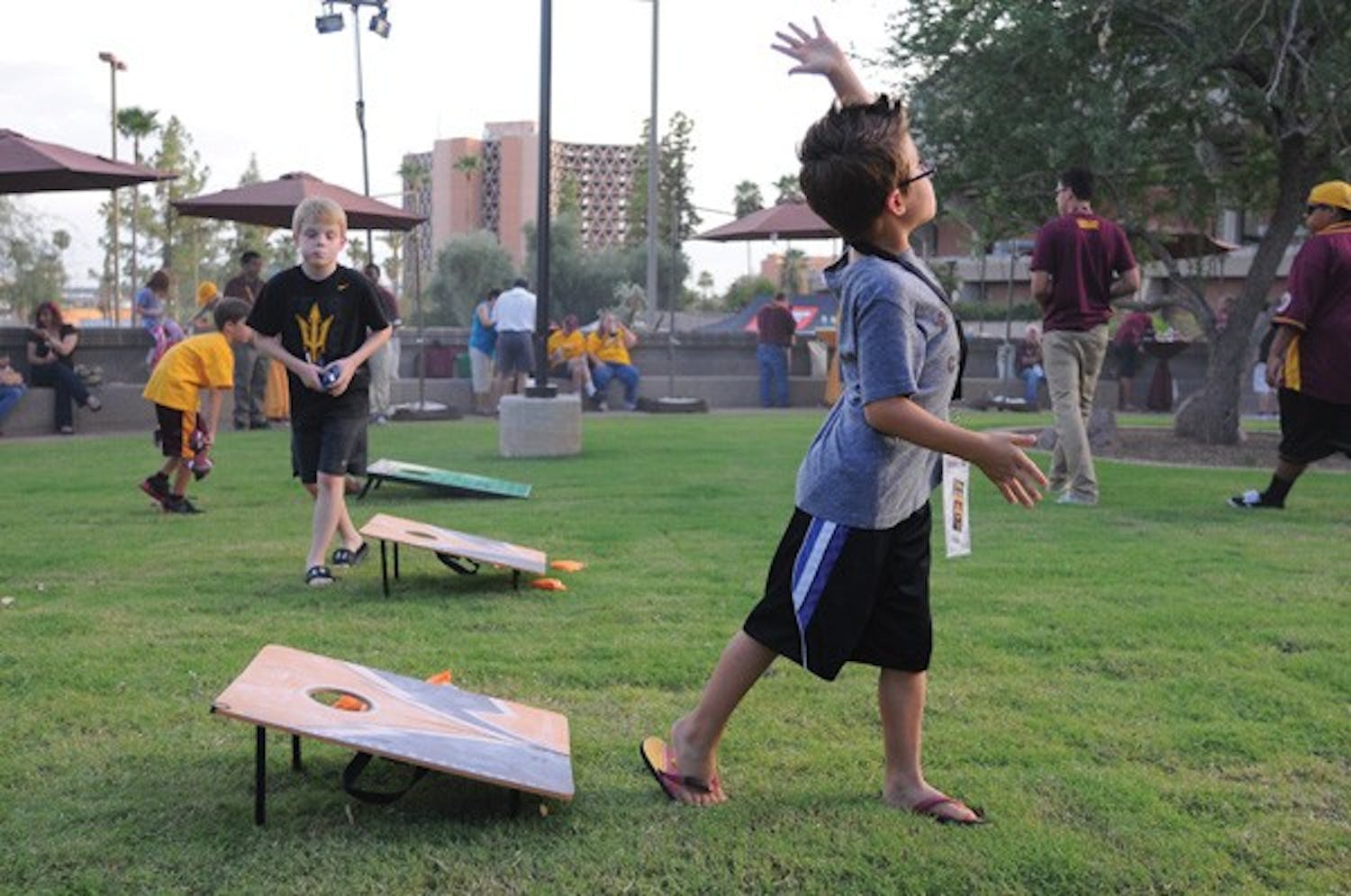 Young ASU fans play cornhole prior to the ASU vs. Utah game Sept. 22 at the Desert Arboretum Park on the Tempe campus. (Photo by Aaron Lavinsky)