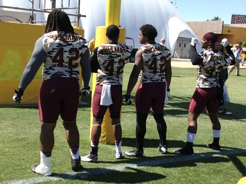 Redshirt defensive tackle Will Sutton, senior cornerback Osahon Irabor and senior safeties Chris Young and Alden Darby show off the backs of their Pat Tillman practice jerseys during Thursday's practice. Coach Todd Graham commended the four seniors with the honorary practice jersey for their leadership on and off the field. (Photo by Justin Janssen)