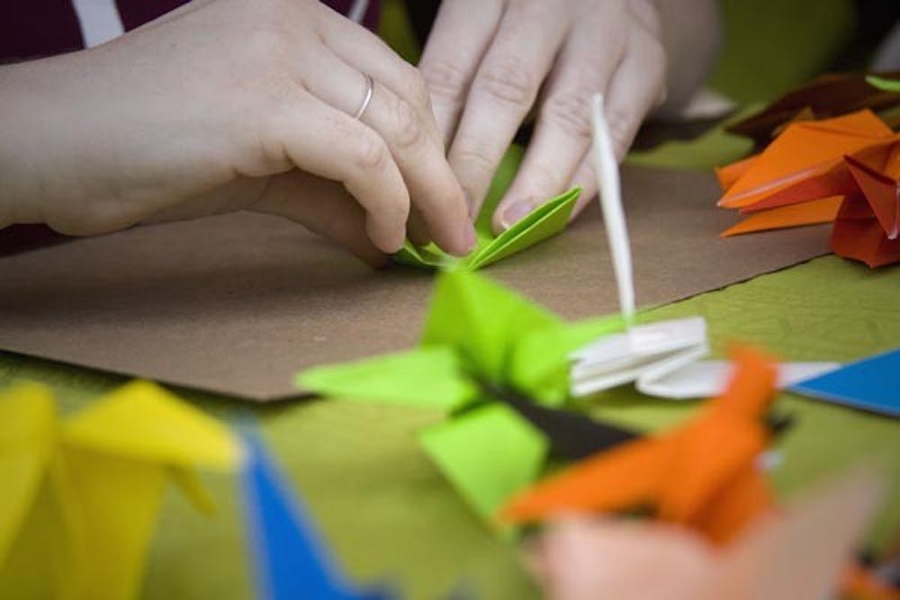 HELPING ALUMNUS: Students from Alpha Rho Chi Fraternity made 3,500 paper cranes on Saturday to raise $3,500 for an alumnus of their fraternity who was diagnosed with Stage 4 brain cancer this year. (Photo by Annie Wechter)