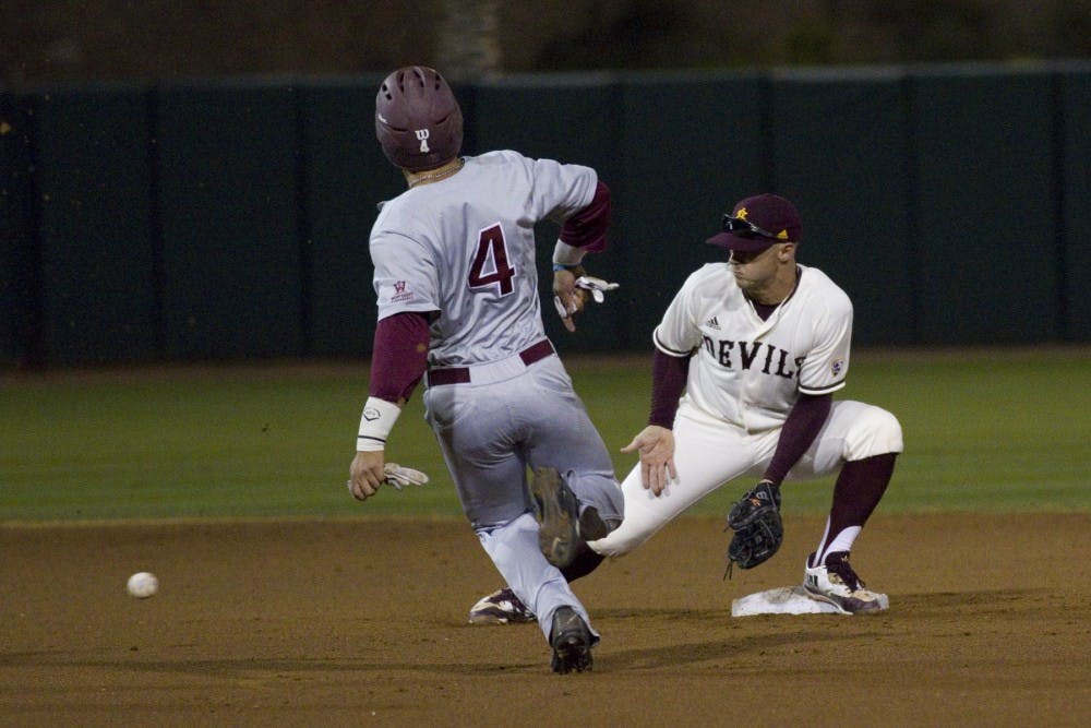 ASU senior second-baseman Jackson Willeford (19) fields a ball at second base with a LMU player sliding in to the base during game one of a baseball series versus Loyola Marymount University at Phoenix Municipal Stadium in Phoenix on Friday, March 3, 2017. ASU won the first game of the series 2-1. 