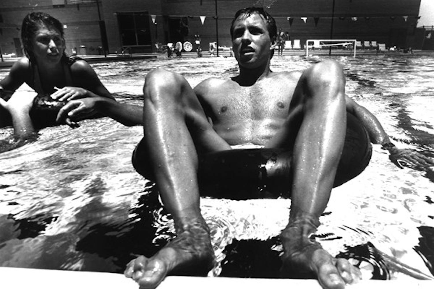 TUBE TEACHERS: Seniors Brad Senska and Michelle Danko prepare for their inner tube relay race at the Student Recreation Center pool on June 20, 1990.  Students in the summer physical education were required to teach one game to other students. (Photo by T.J. Sokol)