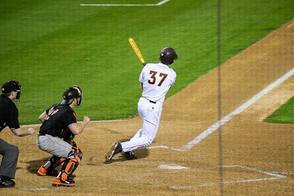 Sophomore shortstop Colby Woodmansee gets a base hit against Oklahoma State, Friday, Feb. 13, 2015, at Phoenix Municipal Stadium. Woodmansee went on to hit a walk-off home run in the bottom of the 10th inning to propel the Sun Devils to a 4-3 win against the Cowboys. (J. Bauer-Leffler/The State Press)