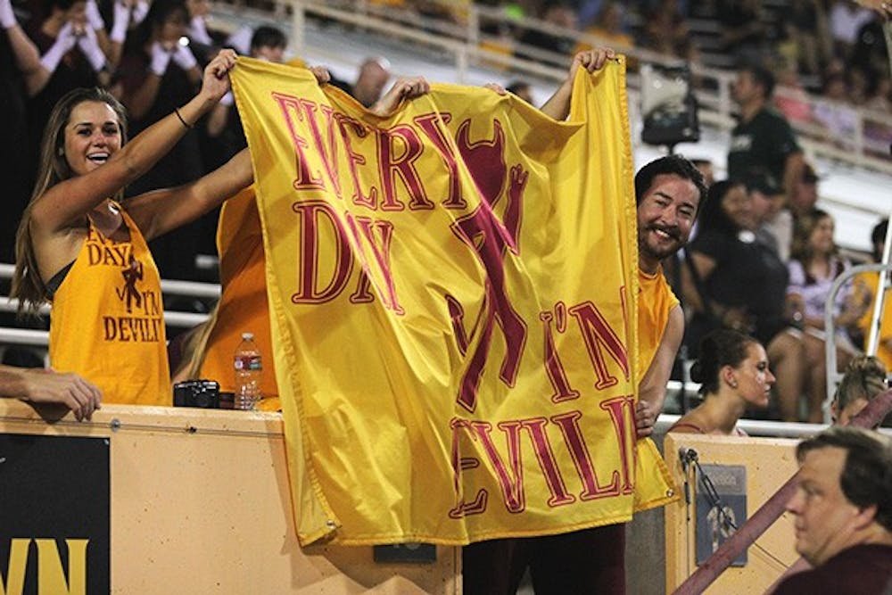 ASU fans wave a flag at a home game in Tempe. The Sun Devils defeated the Utes on the road