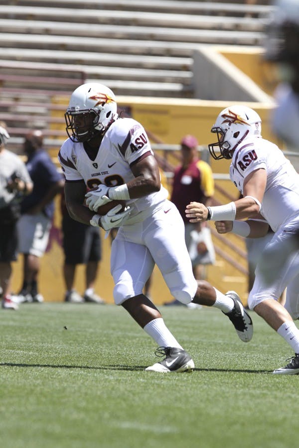 Redshirt senior running back James Morrison receives a handoff during ASU’s Spring Game last April. Morrison and senior wide receiver Jamal Miles return to the team after both were suspended for violating team rules. (Photo by Sam Rosenbaum)
