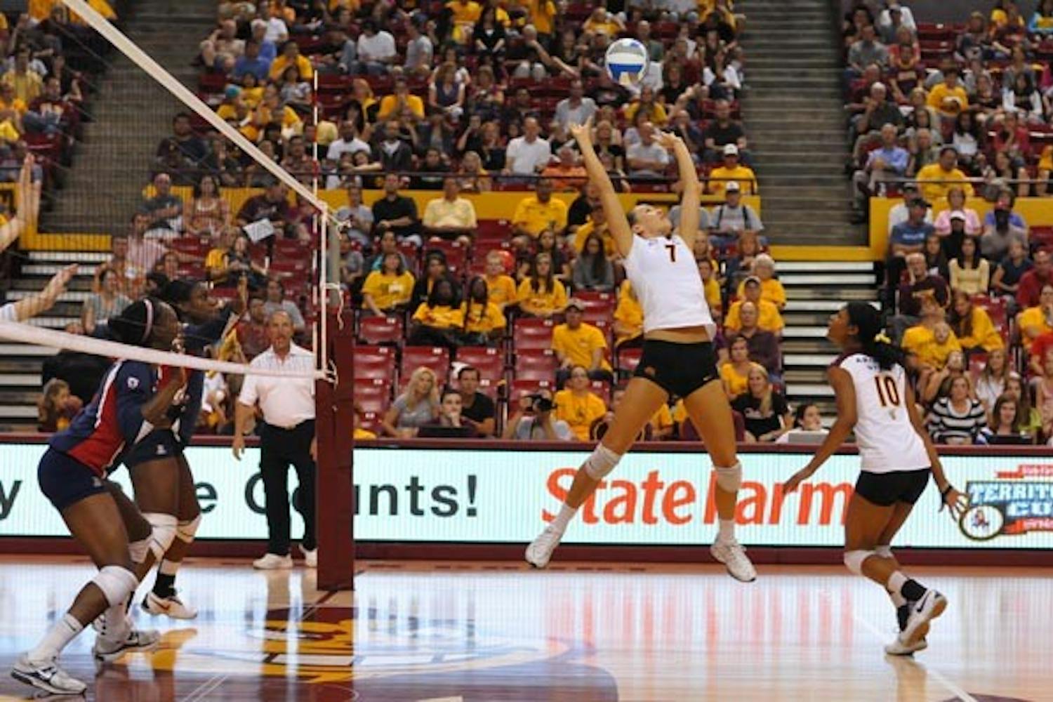 IMMINENT KILL: Junior setter Cat Highmark lofts a set as sophomore middle blocker Erica Wilson prepares for a kill. Hosting Oregon and Oregon State this weekend, the Sun Devils are looking to improve their passing game against tough Pac-10 teams. (Photo by Aaron Lavinsky)