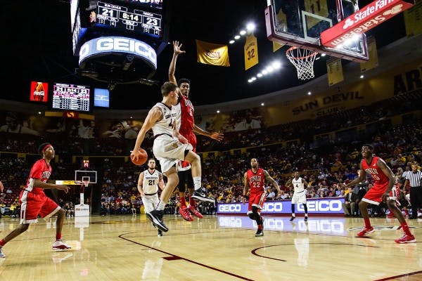 Freshman guard Kodi Justice throws a behind the back pass at the ASU vs UNLV game on Dec. 3rd, 2014 at the Wells Fargo Arena. Justice would control the game in the second half leading the Sun Devils to a 77-55 victory over the Runnin Rebels. (Photo by Daniel Kwon)