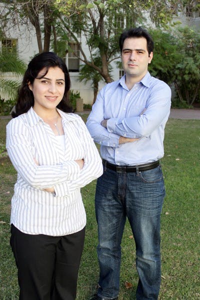 STUDYING SUICIDE: Grad students Azadeh Nikfarjam, left, and Ehsan Emadzadeh, right, are representing ASU in the annual Medical Natural Language Processing Challenge. Their goal is to identify and categorize emotions found in suicide notes. (Photo by Beth Easterbrook)
