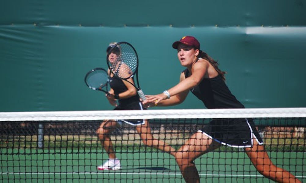 Freshman Ebony Panoho keenly watches her opponent's shot in a doubles game against Pepperdine on Feb. 23. Ebony is the only freshman with a losing record but has instrumental in many Sun Devil victories. (Photo by Murphy Bannerman)