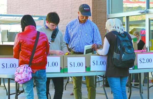 CHEAP READS: Customers browse through the sidewalk book sale outside of the ASU Bookstore. ASU has recently decided to outsource the management of its campus bookstores to Follett Higher Education Group. (Photo by Rosie Gochnour)